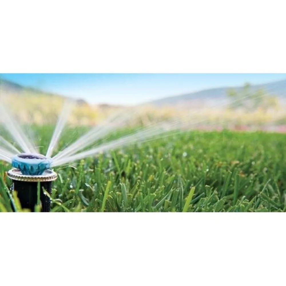 Rotating multi-stream MP Rotator sprinklers watering a hillside lawn and planting beds