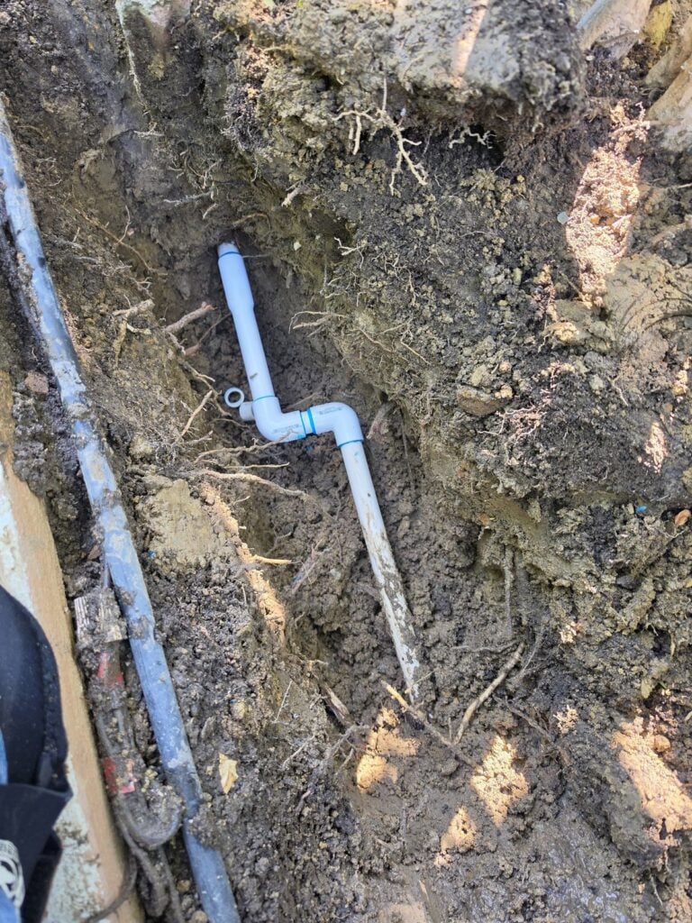 Sprinkler pipe repair rerouted around tree roots - Evergreen Sprinklers